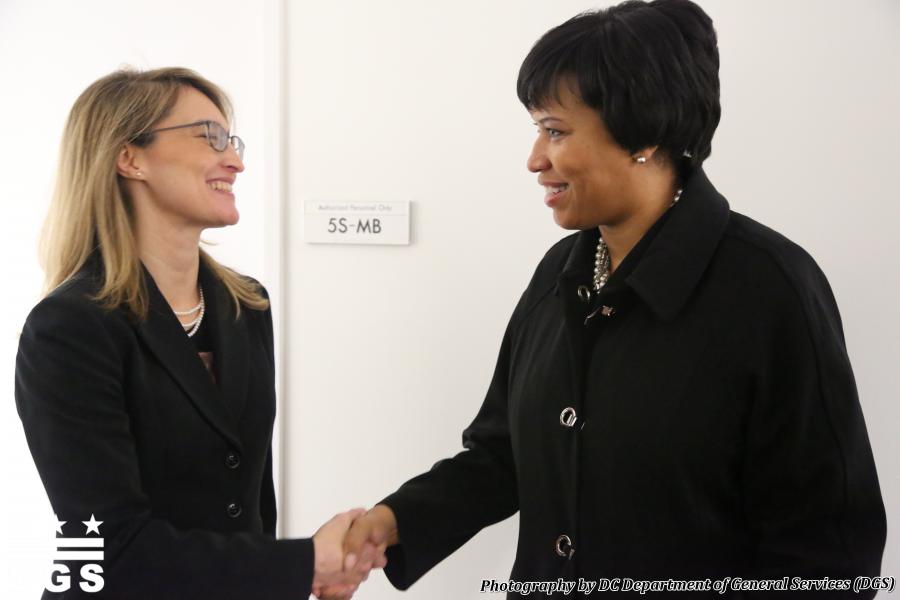 DC Office of Human Rights Director Monica Palacio shakes hands with DC Mayor Muriel Bowser