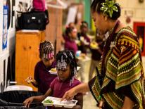 Woman helping children recycle food products