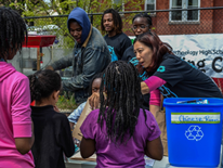 Students from the McKinley Recycling Club and club sponsor, Jen Wang, spend their Saturday afternoon providing recycling information and snacks at a community rally.