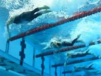 Swimmers racing in lanes underwater in a DC Pool