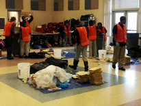 Teams of Walker-Jones sixth grade students sort through their school's kitchen and cafeteria waste to gather data on the waste streams created from their school lunches.